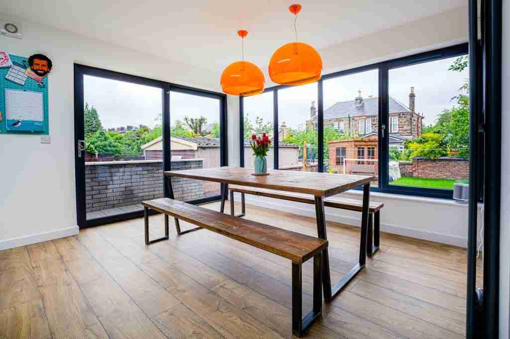 Contemporary flat-roof extension with pale grey brick and large windows in Jordanhill