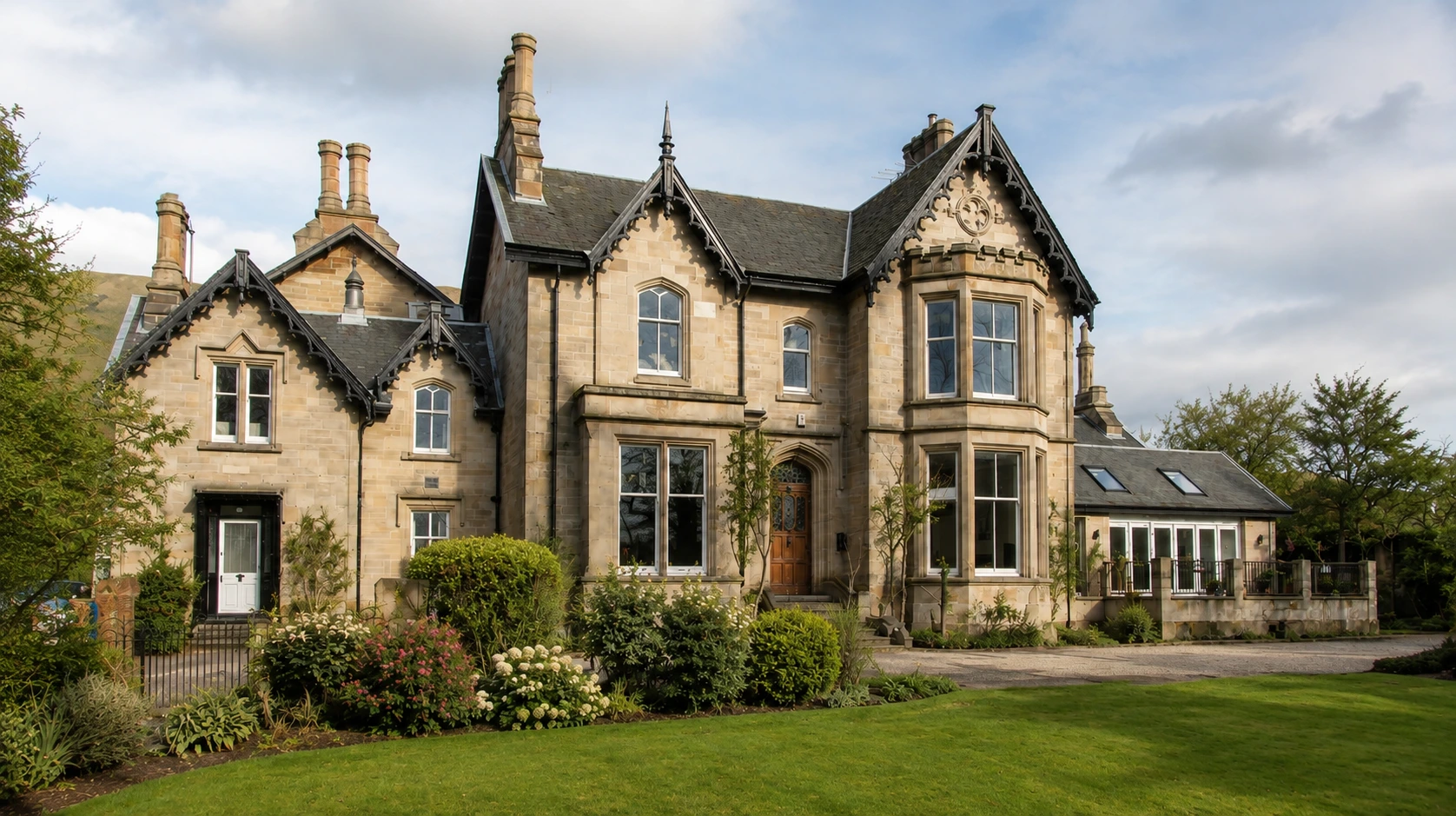 Georgian Mansion in Tiilicoultry with stone elevations, decorative gables, slate roofs and mature landscaped gardens