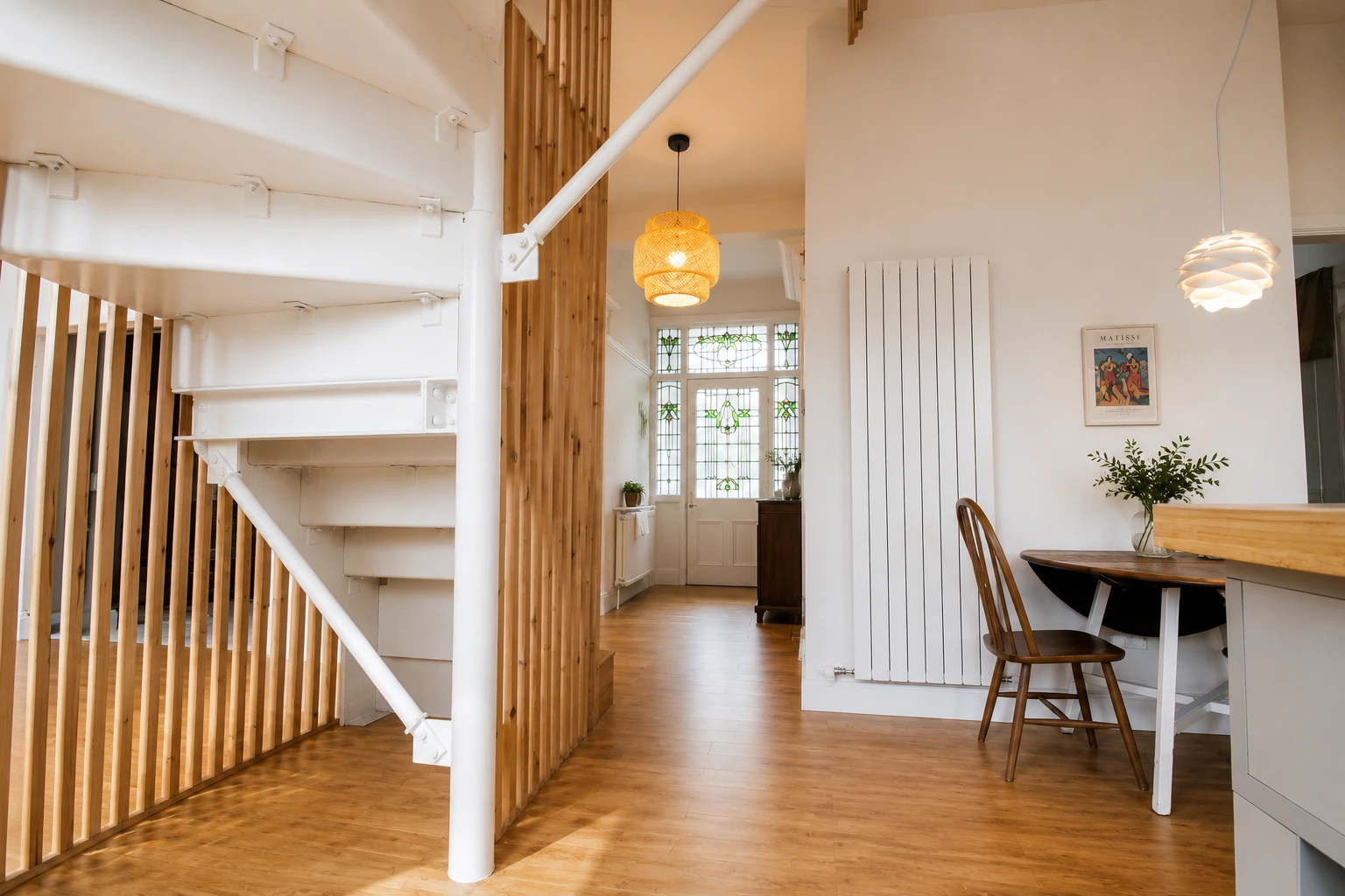 Architectural timber staircase with vertical slatted balustrade and rooflight