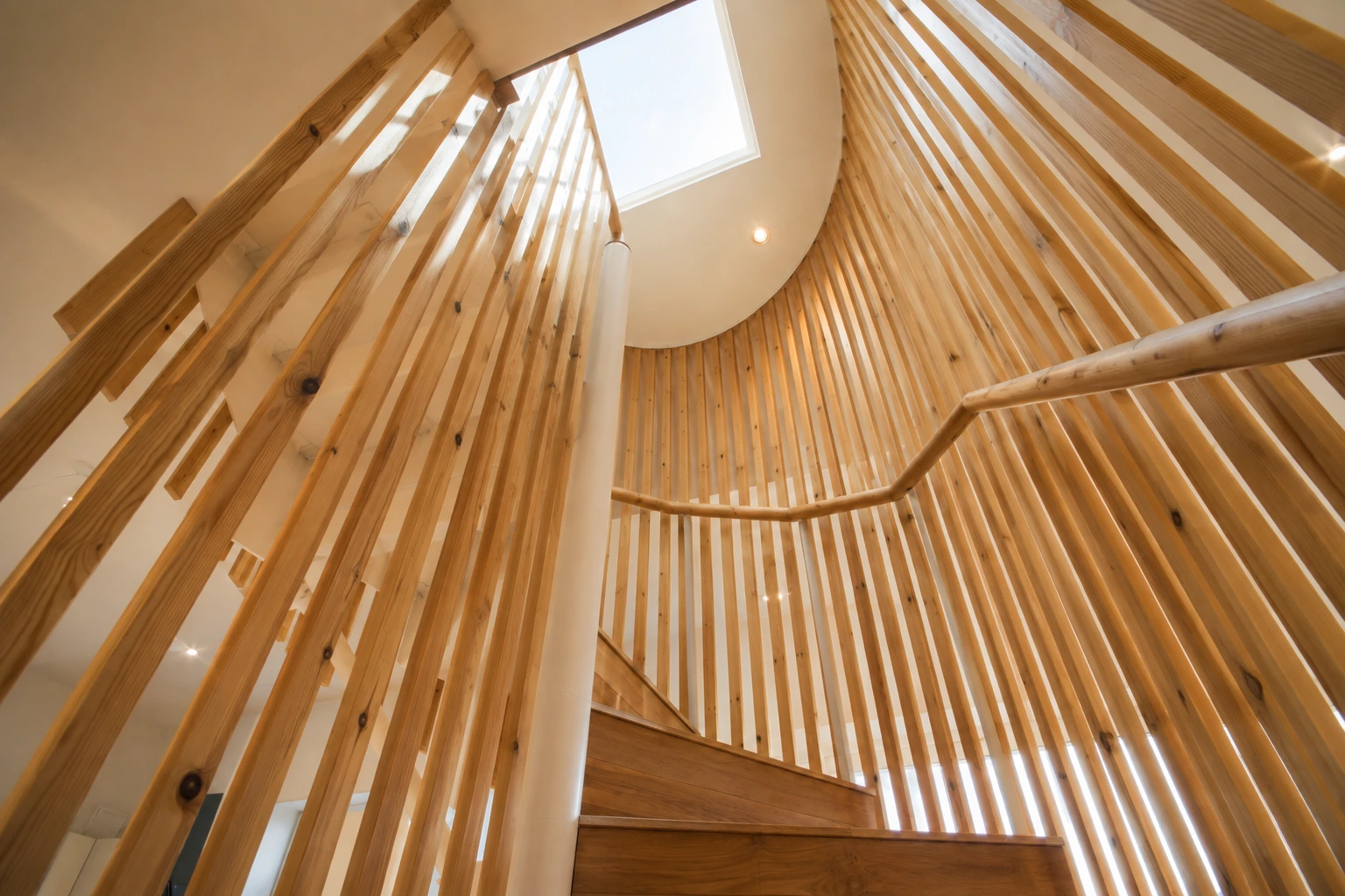 Bespoke timber staircase and vertical slatted screen within an open-plan Glasgow home