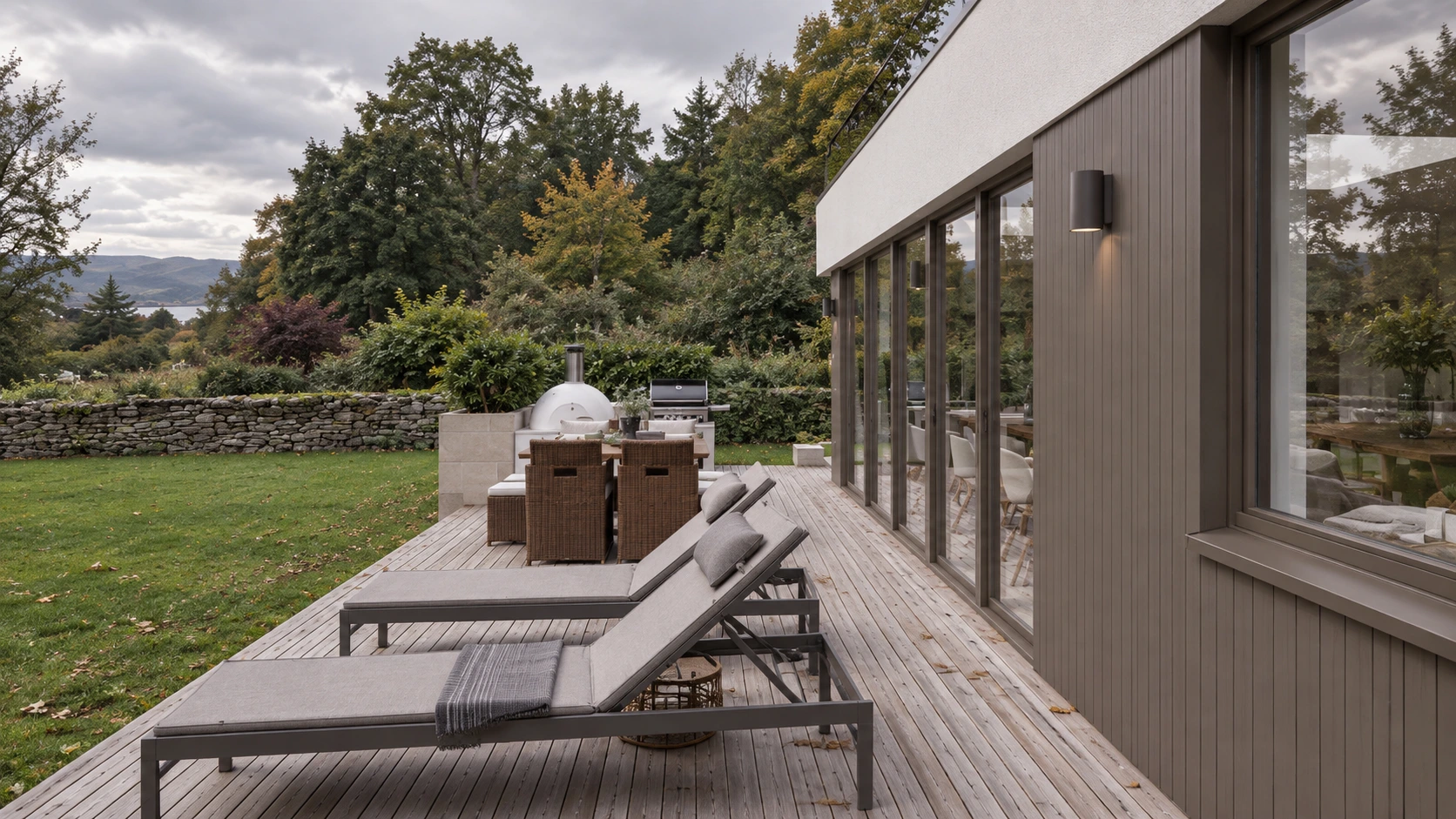 Contemporary rear extension with glazed walls, timber terrace, outdoor dining area and mature landscaped garden