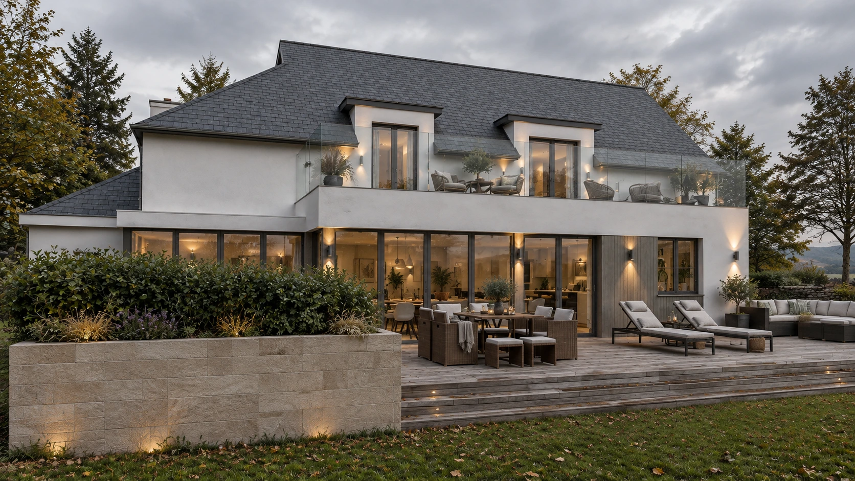 Rear elevation of a contemporary house extension with extensive glazing, upper terrace, mature planting and landscaped garden