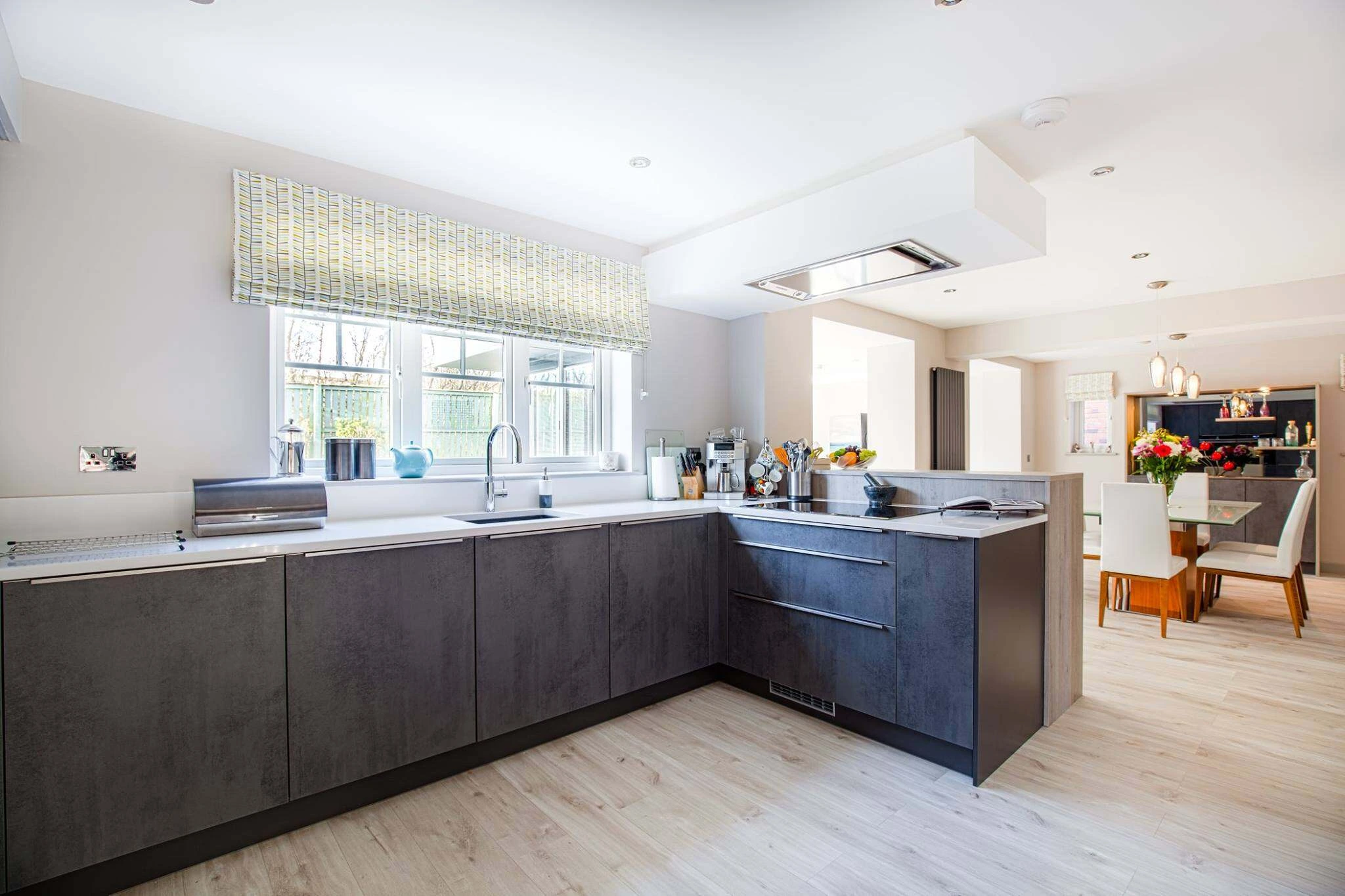 Contemporary kitchen design with generous work surfaces and integrated storage in Newton Mearns