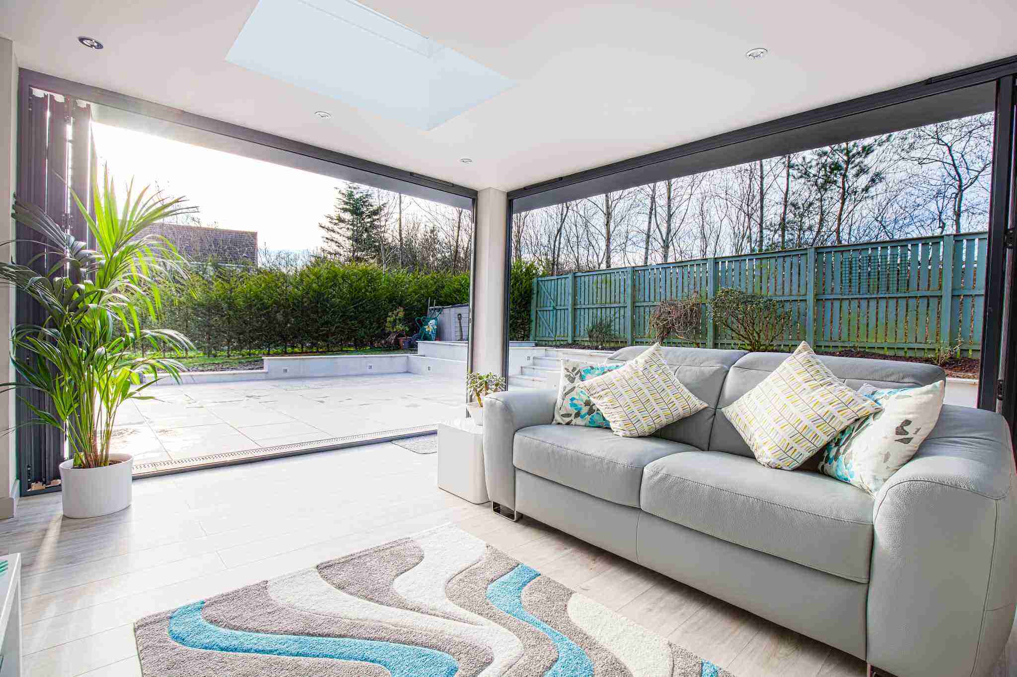 Open-plan living space overlooking the garden through large glazed doors in Newton Mearns