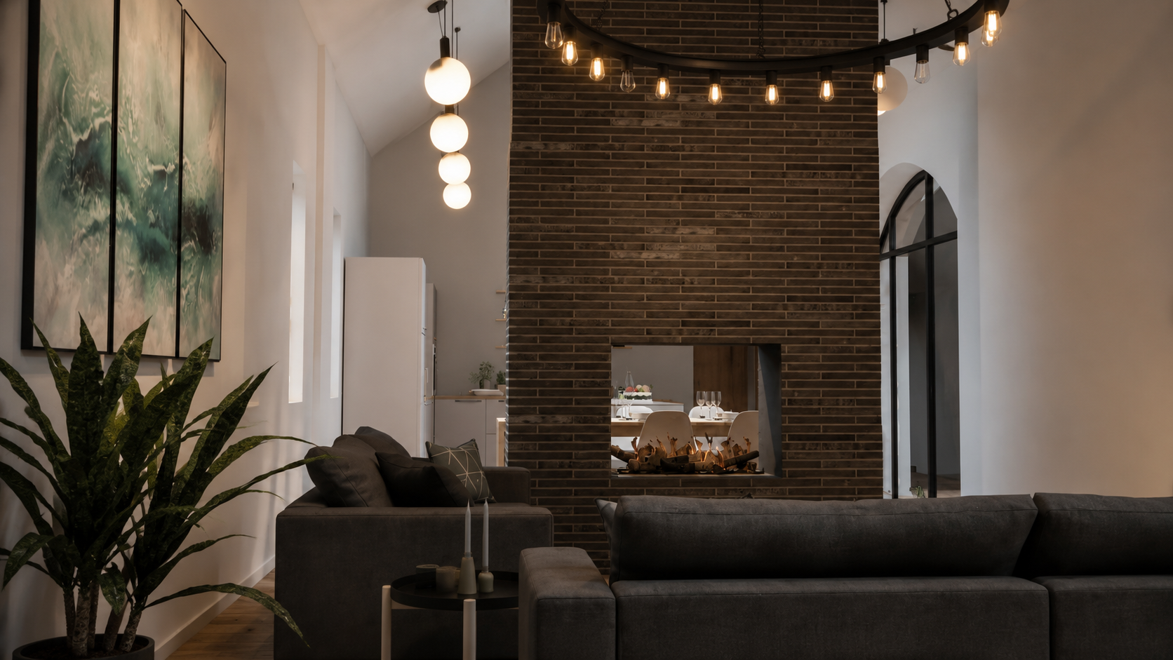 Contemporary living room in a Helensburgh barn conversion with a feature brick fireplace, dark furniture and large arched window.