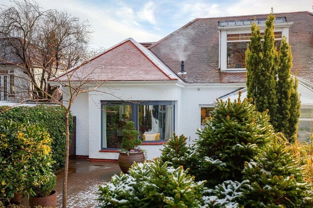 Rear view of a contemporary single-storey house extension in Giffnock designed by Allison Architects