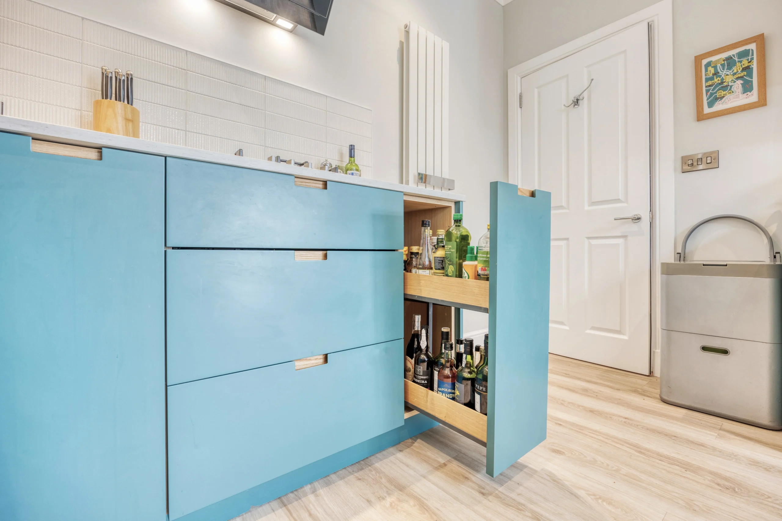 Bespoke kitchen with open oak shelving and blue cabinetry within a Glasgow home extension