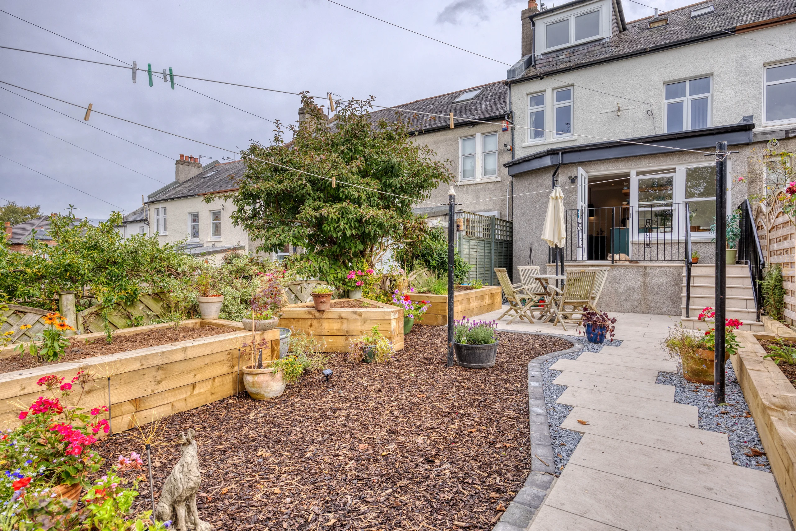 Rear elevation of a Glasgow home showing the glazed house extension and garden terrace