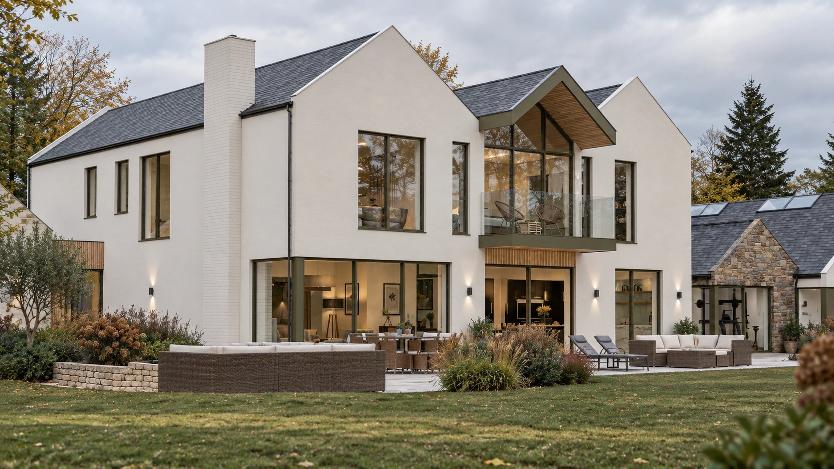 Rear elevation of a contemporary new-build country house opening onto landscaped gardens in West Lothian