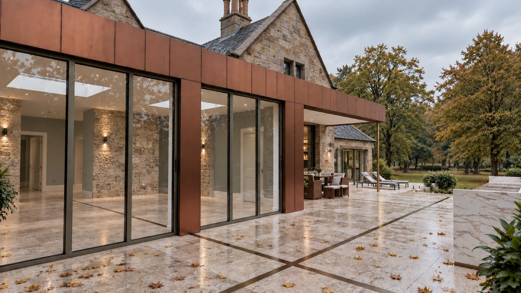 Copper-clad extension with full-height glazing connecting a period country mansion to its landscaped garden